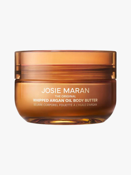 Josie Maran Body Butter in amber branded tub component on a light gray background